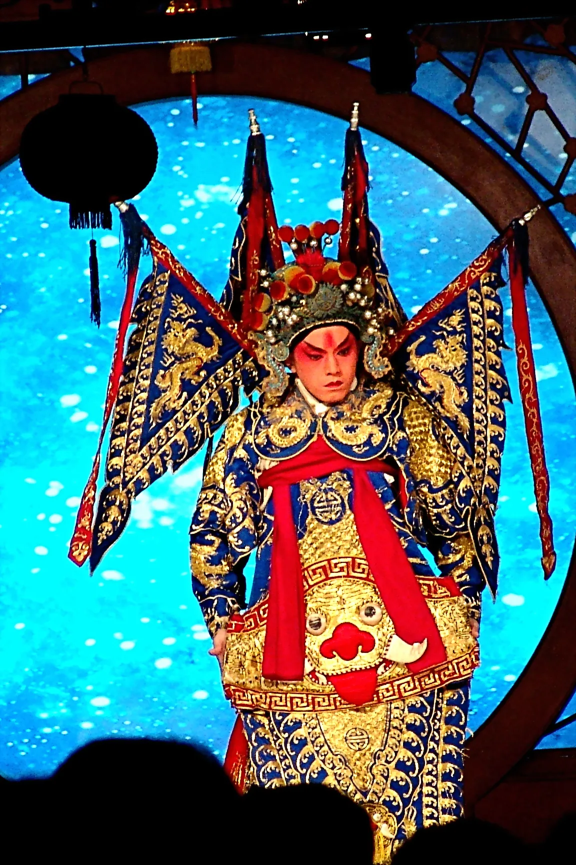A Peking Opera performer in an elaborate embroidered costume and painted face at the Liyuan Theatre, Beijing